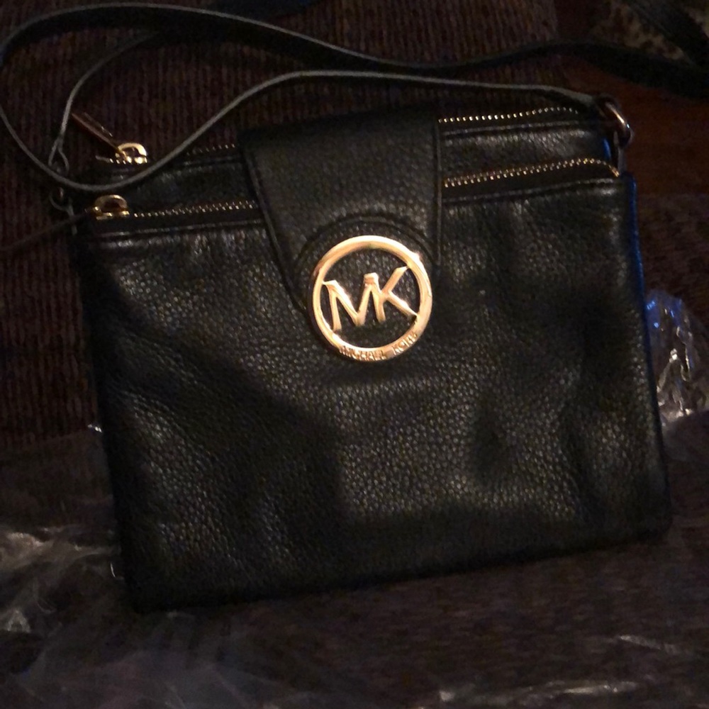 Michael Kors black leather cross body pocketbook.
